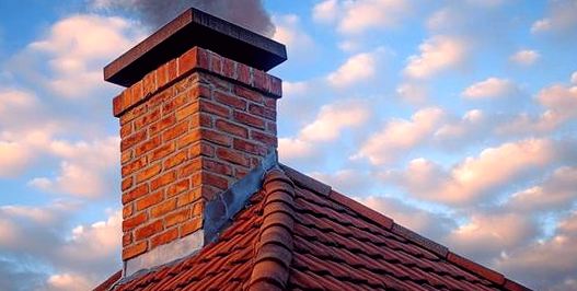 Capped chimney drawing easily against an evening sky