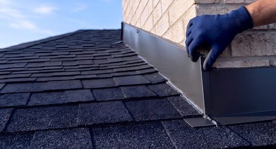 New flashing pressed into its seam against pale brick